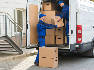 Drivers loading boxes into a delivery van